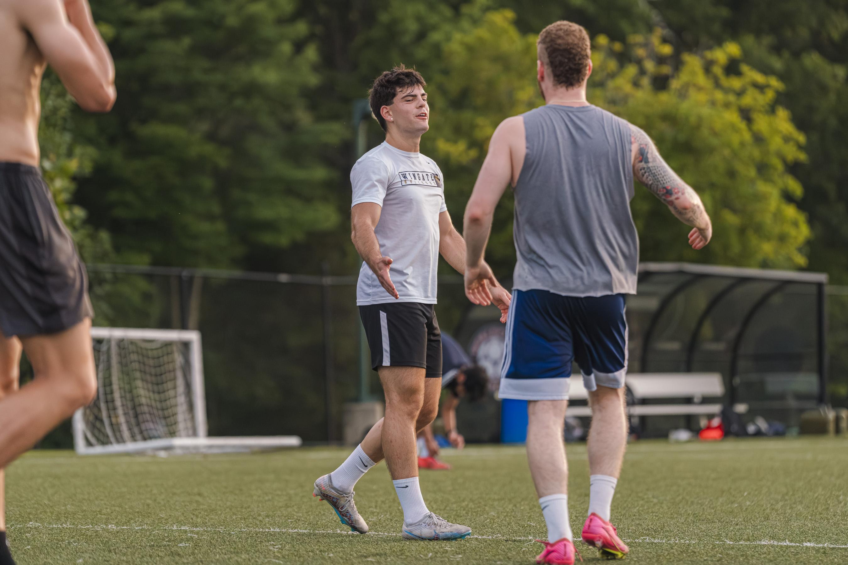 Teammates talking on the pitch